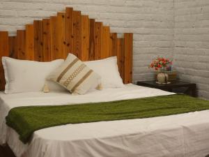 a large white bed with a green blanket and pillows at căn 3 ngủ in Ấp Tân Long +12 photos