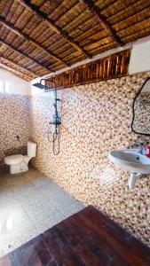 a bathroom with a sink and a toilet at Dom Dom Guest House Gili Gede in Gili Gede +17 photos
