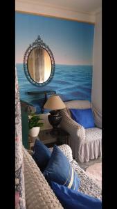 a living room with a mural of the ocean at Mistela Altos Crucero Boutique - Alojamiento temático - Zona Residencial Ciudad - Viajes al Aeropuerto - in Godoy Cruz +23 photos