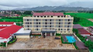 an aerial view of a hotel with a parking lot at vangvieng THAVIKUN HOTEL in Vang Vieng