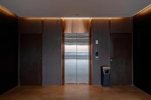 a hallway with two elevators and a silver elevator at vangvieng THAVIKUN HOTEL in Vang Vieng