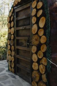 a wooden door with a bunch of logs at En medio de la nada in Mazamitla