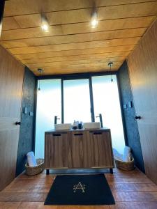 a bathroom with two sinks and a large window at Disfruta del Bosque in Mazamitla