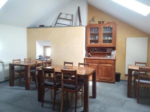 a dining room with tables and chairs and a ladder at Guesthouse "Castello del Nucleo" in Intragna