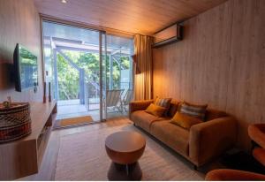 a living room with a couch and a large window at K204 junto à Universidade in Guimarães