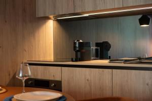 a kitchen with a table with a wine glass on it at K204 junto à Universidade in Guimarães