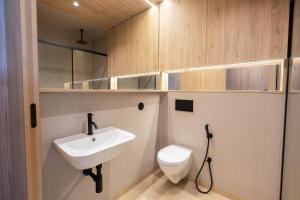 a bathroom with a white sink and a toilet at K204 junto à Universidade in Guimarães +28 photos