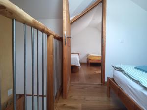 a hallway with a staircase and a bed in a room at Guesthouse "Castello del Nucleo" in Intragna