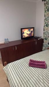 a bedroom with a bed with a flat screen tv on top at Room 1 Bright Spacious Room Walk to Shops in Kelmscott