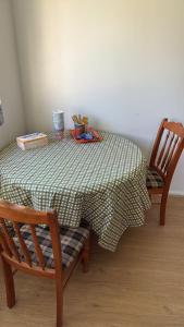 a table with two chairs and a green and white table cloth at Room 1 Bright Spacious Room Walk to Shops in Kelmscott