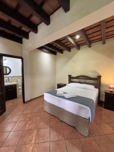 a bedroom with a large bed in a room at Alana Hotel By ISH in Antigua Guatemala