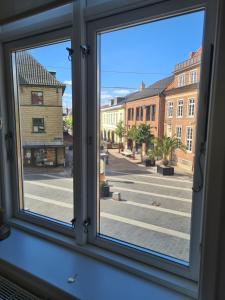 a window with a view of a city street at Damm Hotell in Frederikshavn