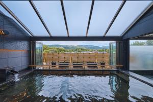 a room with a pool of water with a large window at Wakasa Annex in Nara