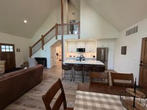 a kitchen and living room with a couch and a table at Hungry Horse Farmhouse in Hungry Horse