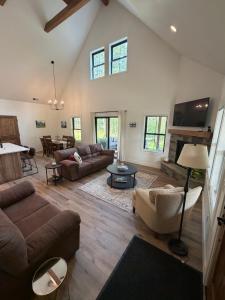 a living room with a couch and a table at Hungry Horse Farmhouse in Hungry Horse