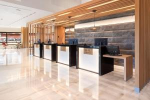 a lobby with a row of counters with computers at Meliá Costa del Sol in Torremolinos
