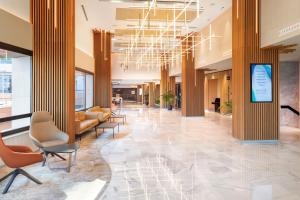a lobby with couches and chairs in a building at Meliá Costa del Sol in Torremolinos