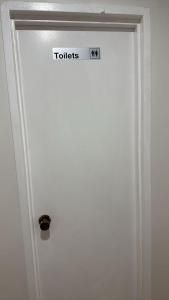 a door with a sign that says toilets on it at Room 2 Bright Spacious Room Walk to Shops in Kelmscott