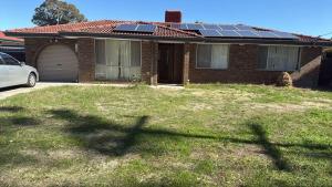 a house with solar panels on top of it at Room 2 Bright Spacious Room Walk to Shops in Kelmscott