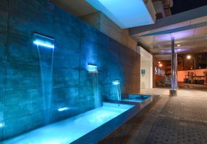 a swimming pool in a building with a blue wall at SOL by Meliá Torremolinos Don Pablo in Torremolinos