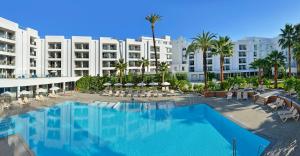 a large hotel with a swimming pool in front of a building at SOL by Meliá Torremolinos - Don Pedro in Torremolinos