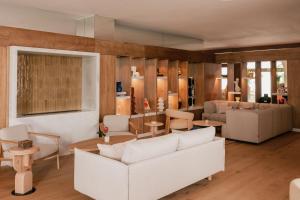 a living room with a white couch and tables at ME by Meliá Marbella in Marbella