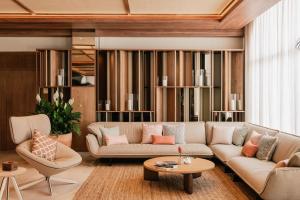 a living room with a couch and chairs at ME by Meliá Marbella in Marbella
