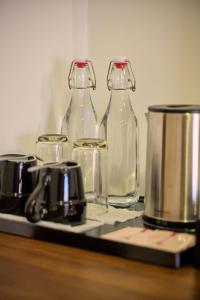two glass bottles sitting on top of a counter at THE RIVERFRONT CENTRAL Hotel in Siem Reap