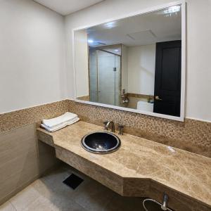 a bathroom with a sink and a mirror at Centum Convention Hotel In Centum in Busan +52 photos