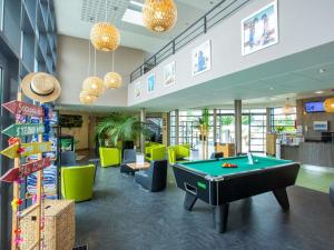 a pool table in the middle of a lobby at Hôtel Ibis Styles Bourges in Bourges
