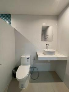 a bathroom with a toilet and a sink at Naiharn On The Rock Resort Phuket in Nai Harn Beach