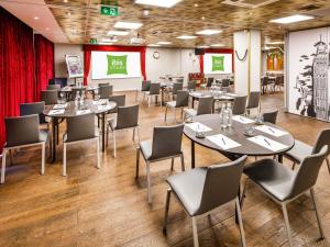 a restaurant with tables and chairs in a room at ibis Styles London Southwark - near Borough Market in London