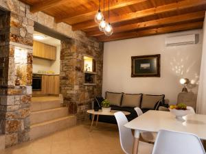 a living room with a couch and a table at Blue Topaz cottage Mini pool Spa in Nafplio