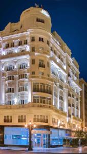 a large white building with a round top at Meliá Plaza Valencia in Valencia