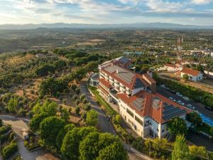 an aerial view of a building with solar panels on its roof at Meliá Castelo Branco in Castelo Branco
