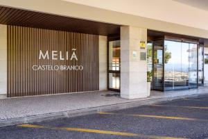 a building with a sign on the side of it at Meliá Castelo Branco in Castelo Branco