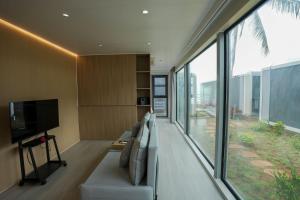 a living room with a couch and a television at Sea Side Resort in Paje
