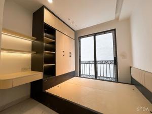 a walk in closet with a large window at Sunshine Housse with Balcony in Centre in Ho Chi Minh City