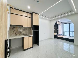 a kitchen with a sink and a large window at Sunshine Housse with Balcony in Centre in Ho Chi Minh City