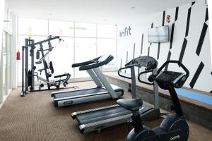 a gym with three exercise bikes in a room at INNSiDE by Meliá Yogyakarta in Yogyakarta