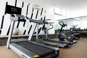 a gym with several treadmills and cardio machines at INNSiDE by Meliá Yogyakarta in Yogyakarta