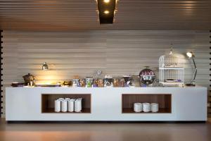 a kitchen with a white counter with a bird cage on it at INNSiDE by Meliá Yogyakarta in Yogyakarta +26 photos