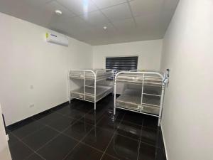 a room with two metal trays on a black floor at Casa playa el Retén  +4 photos