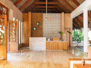 a lobby of a resort with a reception desk at Zel Punta Cana - All Suites - All Inclusive in Punta Cana