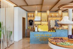a coffee shop with a blue counter in a room at Zel Punta Cana - All Suites - All Inclusive in Punta Cana