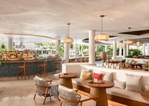 a restaurant with tables and chairs and a bar at Zel Punta Cana - All Suites - All Inclusive in Punta Cana +36 photos