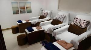 a room with four beds with pillows on them at Time Travellers Hotel in Manila