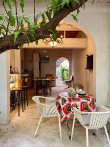 a dining room with a table and chairs and a tree at Brother House in Nha Trang