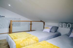 a bedroom with two beds and a sign on the wall at Alfama Apartment with River view in Lisbon
