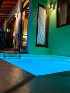 a swimming pool with blue lights in a building at Riverdale lagoon villas in Aluthgama